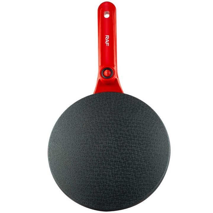 Nonstick frying pan with red handle and textured black cooking surface