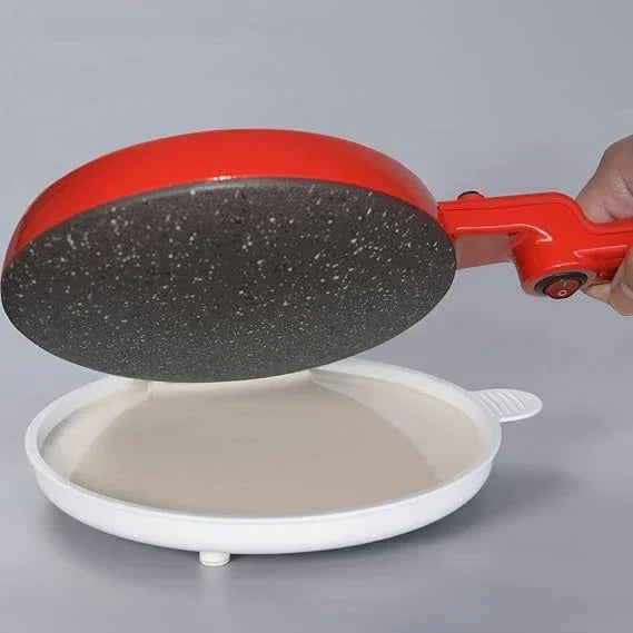 Electric crepe maker with non-stick surface dipping into batter for easy pancake making