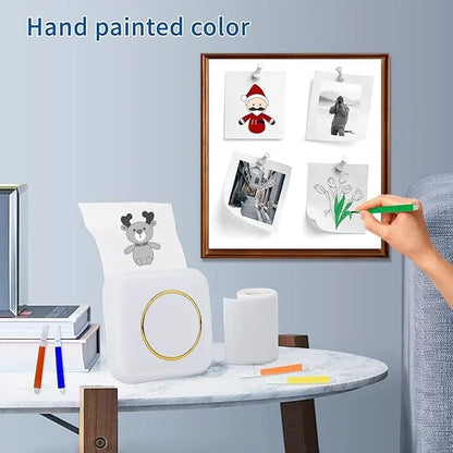Mini thermal printer on table printing cartoon image, hand coloring printed photo, creative display